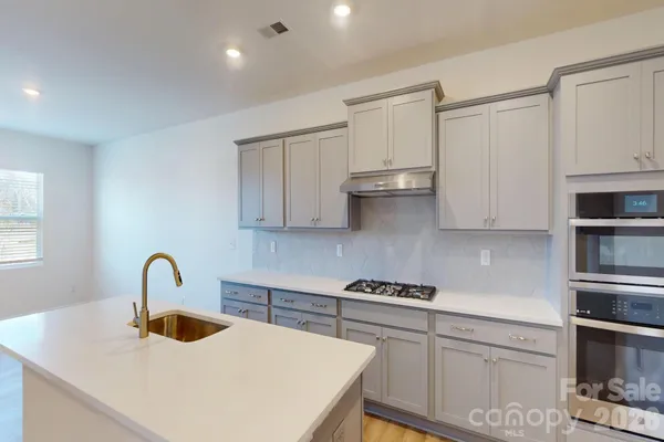 a kitchen with stainless steel appliances sink and cabinets