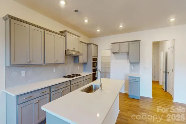 a kitchen with stainless steel appliances a refrigerator sink and cabinets