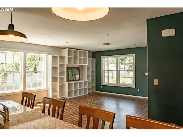 a view of a dining room with furniture and a chandelier