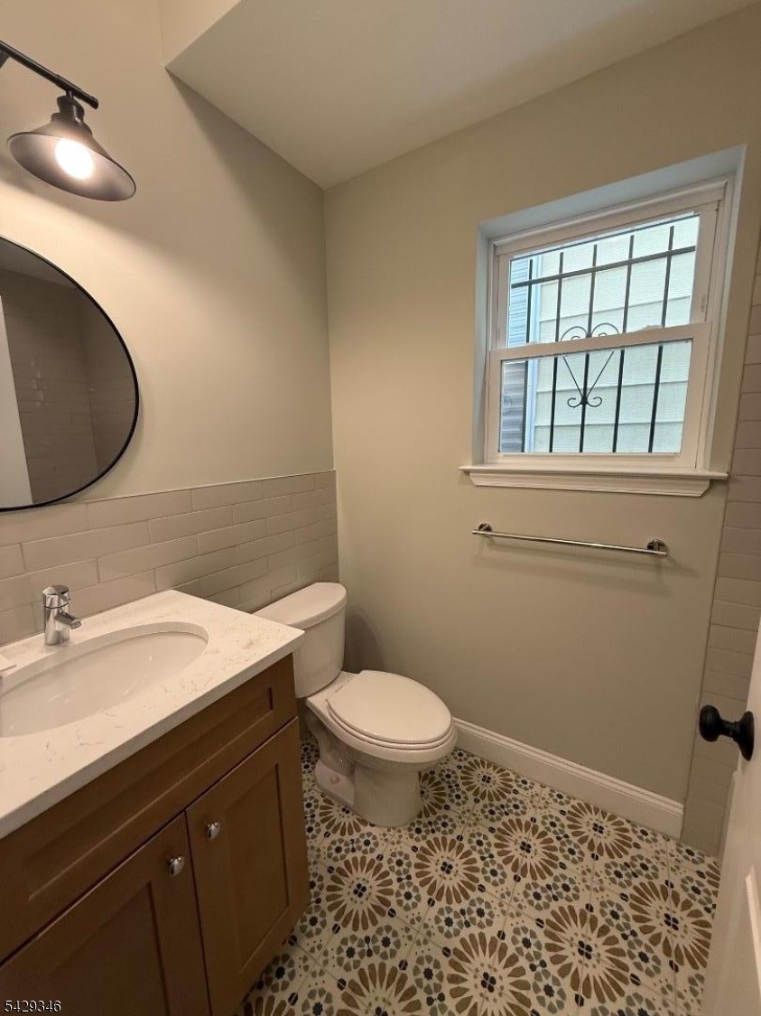 223 South 11th Street Newark, NJ 07107 - Photo 11 of 11 a bathroom with a sink toilet and a mirror