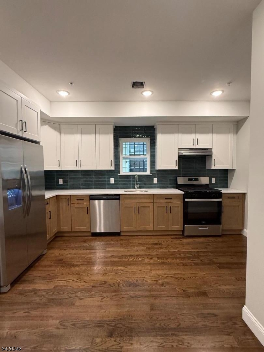 223 South 11th Street Newark, NJ 07107 - Photo 2 of 11 a large kitchen with granite countertop a stove top oven a sink dishwasher and a refrigerator