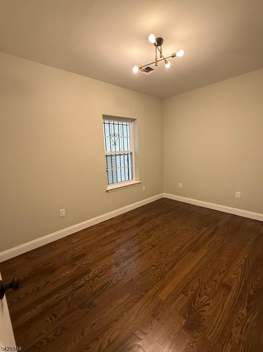223 South 11th Street Newark, NJ 07107 - Photo 5 of 11 wooden floor in an empty room with a window