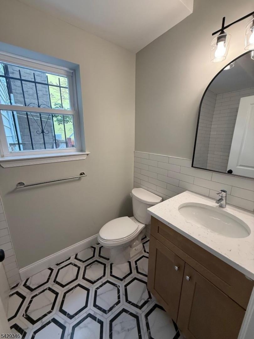 223 South 11th Street Newark, NJ 07107 - Photo 7 of 11 a bathroom with a sink toilet and mirror