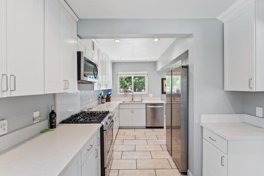 261 Wheelock Road Watsonville, CA 95076 - Photo 7 of 44 a kitchen with a sink a counter top space and appliances