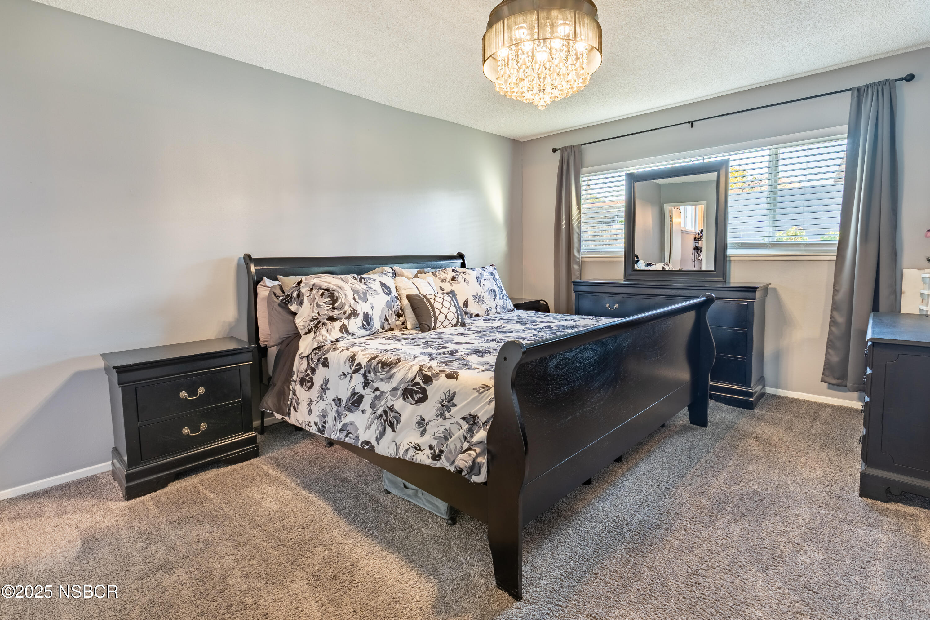 3478 Via Cortez Lompoc, CA 93436 - Photo 12 of 19 a bed room with a bed and a chandelier