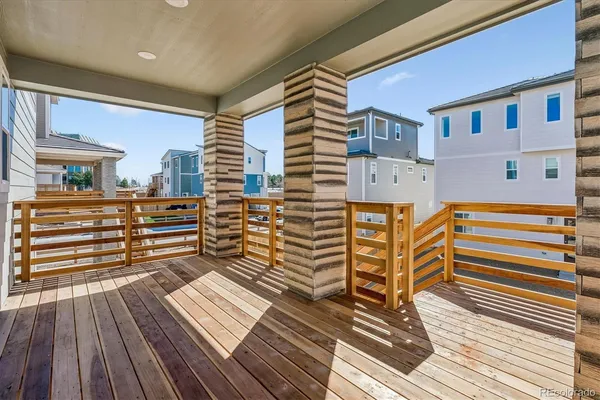 a view of a balcony with wooden floor and furniture