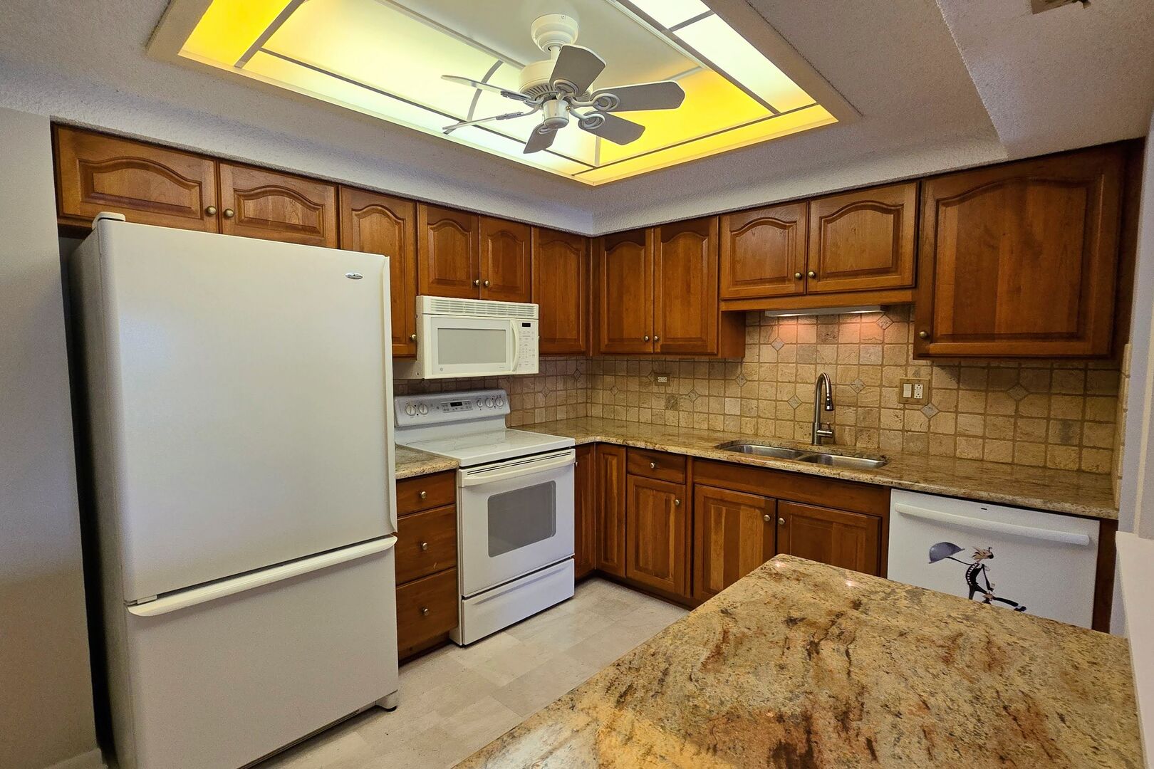 690 Chandler Road, Unit 207 Gurnee, IL 60031 - Photo 5 of 17 a kitchen with stainless steel appliances granite countertop a refrigerator a sink dishwasher a stove with wooden cabinets and floor