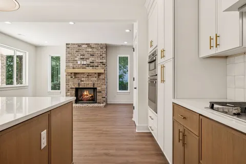a view of a kitchen with a sink a refrigerator and window