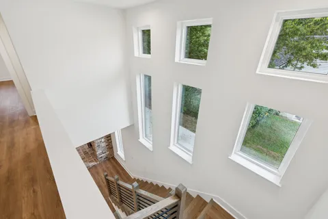 a view of front door with furniture and a window