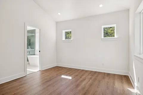 a en suite bathroom with a sink a mirror a bathtub and shower