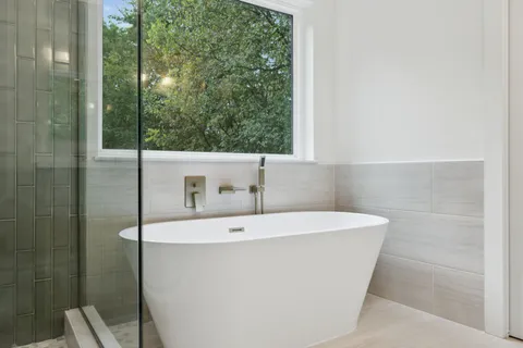 a bathroom with a bathtub and shower