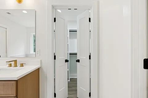 a view of walk in closet with empty racks