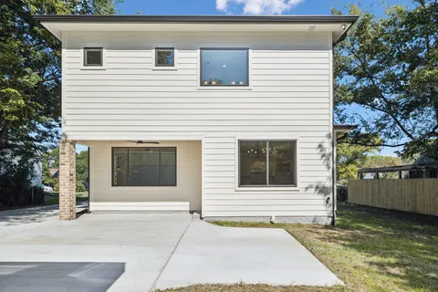 a view of a small house with backyard