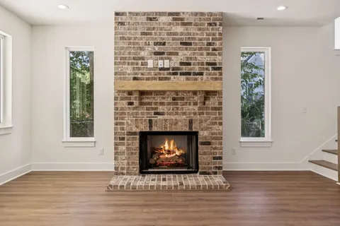 a living room with a fireplace and a wooden floor