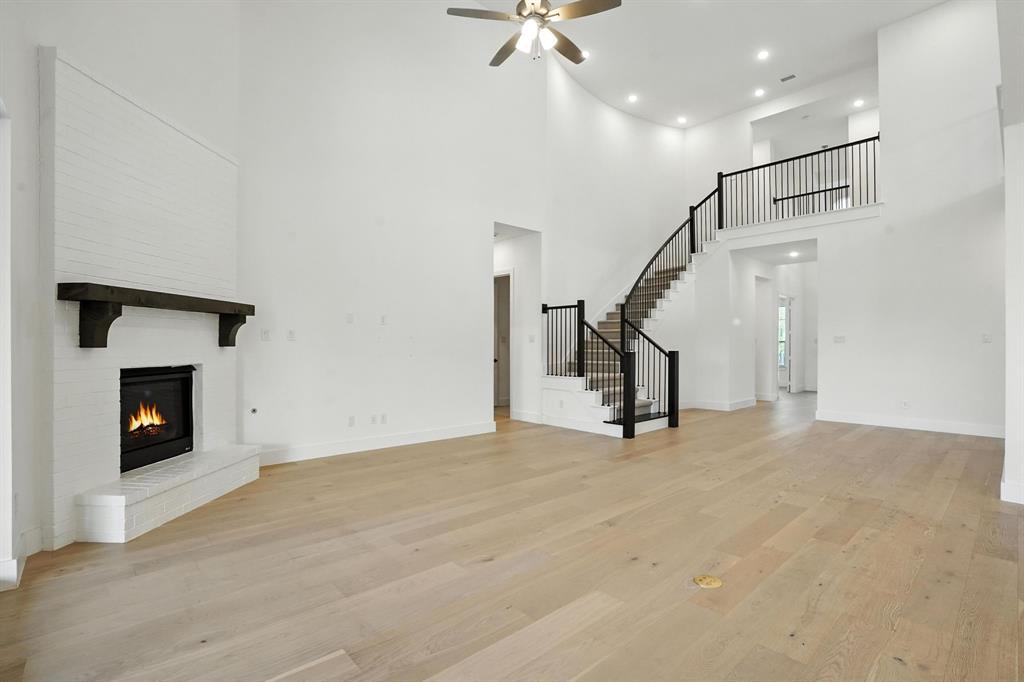 4621 Mount Vista Road Oak Point, TX 75068 - Photo 8 of 40 a view of empty room with fireplace and stairs