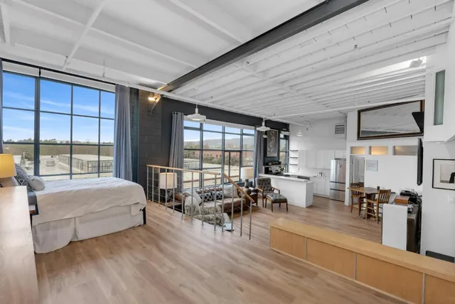 a bedroom with furniture and large windows