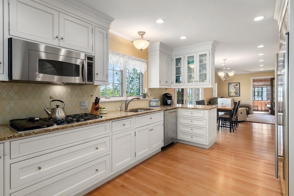 35 Shaw Road Brookline, MA 02467 - Photo 14 of 40 a kitchen with stainless steel appliances kitchen island granite countertop a sink and cabinets