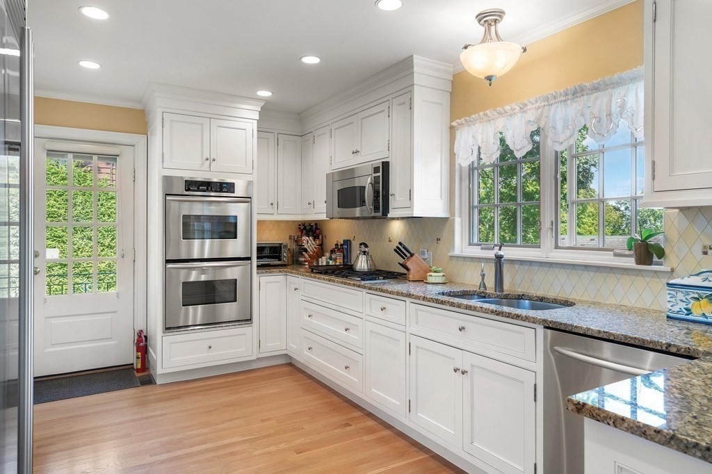 35 Shaw Road Brookline, MA 02467 - Photo 15 of 40 a kitchen with granite countertop a stove a sink and a window
