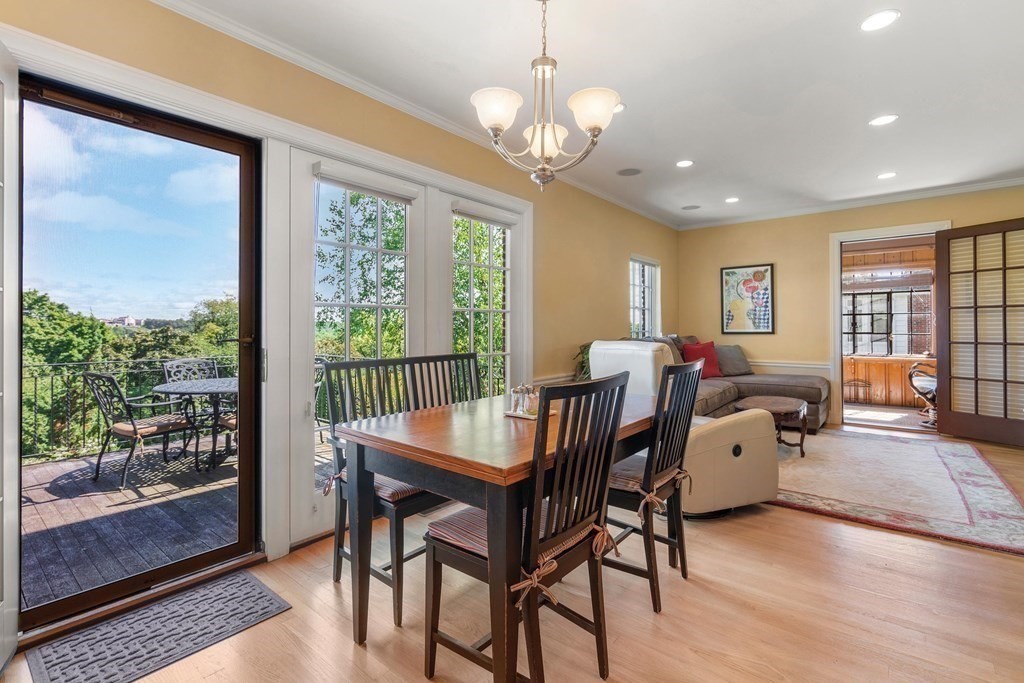 35 Shaw Road Brookline, MA 02467 - Photo 16 of 40 a view of a dining room with furniture large windows and wooden floor