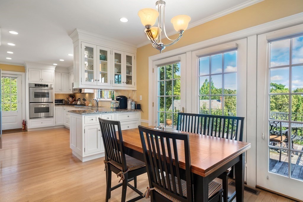 35 Shaw Road Brookline, MA 02467 - Photo 17 of 40 a dining room with furniture a chandelier and wooden floor