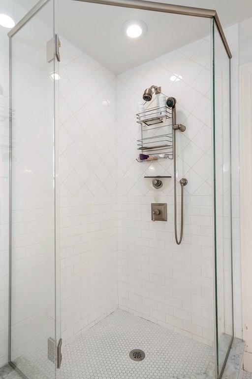 35 Shaw Road Brookline, MA 02467 - Photo 24 of 40 a bathroom with a shower and a glass door
