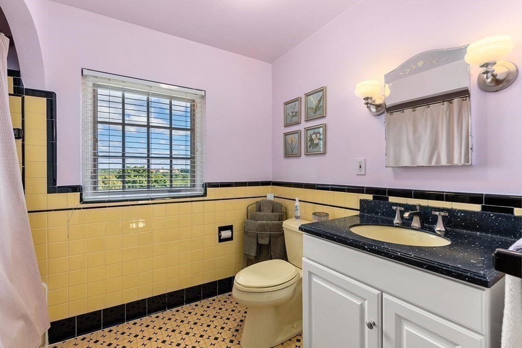 35 Shaw Road Brookline, MA 02467 - Photo 28 of 40 a bathroom with a sink a toilet and mirror