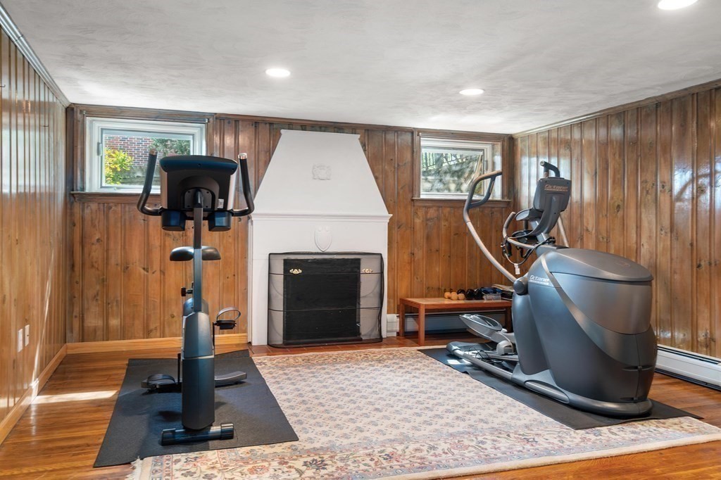 35 Shaw Road Brookline, MA 02467 - Photo 30 of 40 a living room with furniture a rug and a fireplace