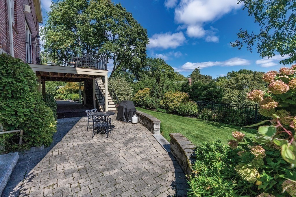 35 Shaw Road Brookline, MA 02467 - Photo 35 of 40 a view of an chairs and fire pit in the backyard