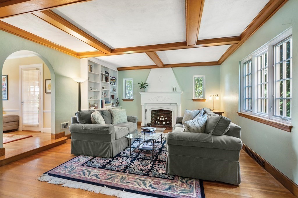 35 Shaw Road Brookline, MA 02467 - Photo 9 of 40 a living room with furniture a fireplace and a large window