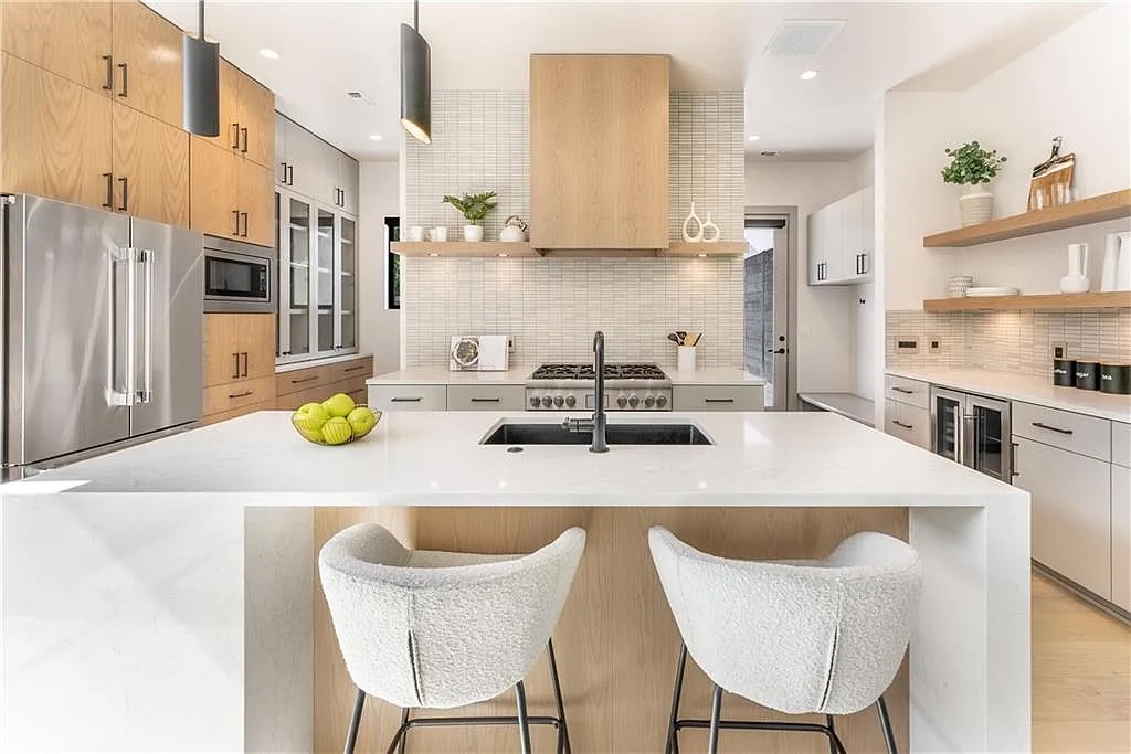 2402 South 3rd Street, Unit A Austin, TX 78704 - Photo 1 of 1 a kitchen with a sink a stove and chairs