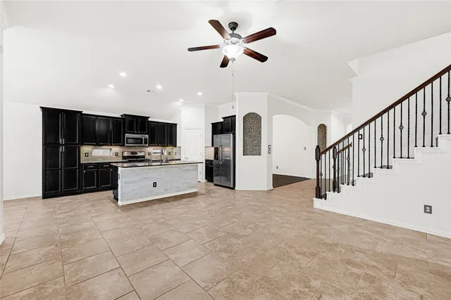 a view of kitchen with microwave and cabinets