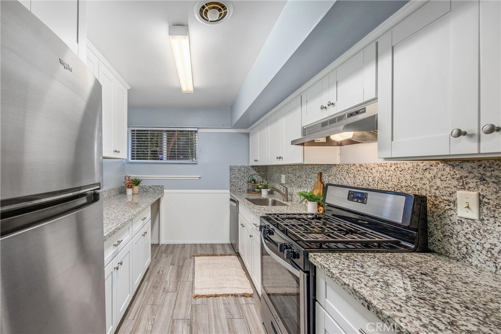 135 North Center Street Redlands, CA 92373 - Photo 12 of 36 a kitchen with a stove and a sink