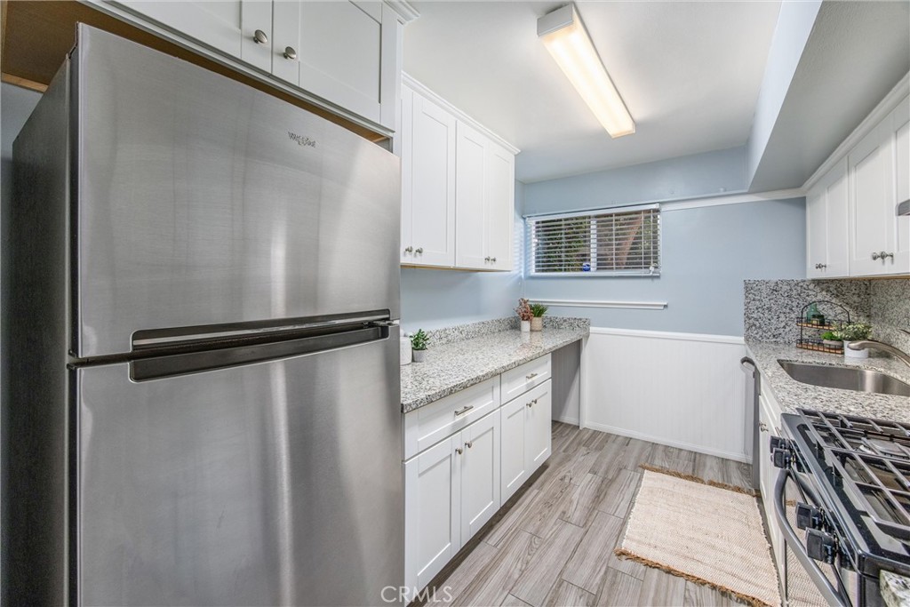135 North Center Street Redlands, CA 92373 - Photo 14 of 36 a kitchen with a refrigerator a sink and a stove top oven
