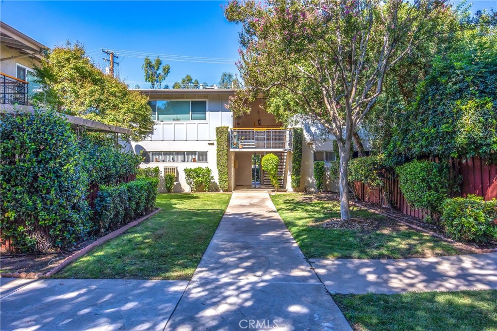 135 North Center Street Redlands, CA 92373 - Photo 3 of 36 a front view of a house with garden