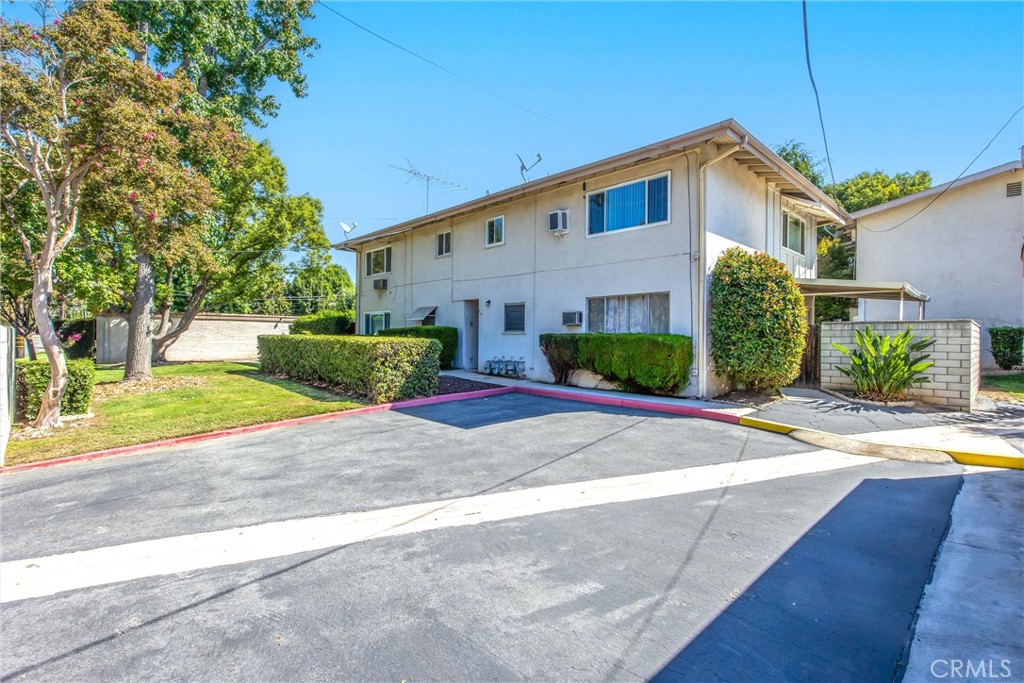 135 North Center Street Redlands, CA 92373 - Photo 32 of 36 a front view of a house with a yard and garage