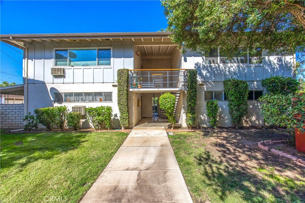 135 North Center Street Redlands, CA 92373 - Photo 4 of 36 a front view of a house with a yard and potted plants