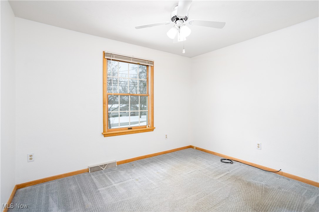 750 Silvercrest Road Wadsworth, OH 44281 - Photo 17 of 35 Carpeted spare room with a ceiling fan, visible vents, and baseboards