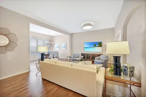 a living room with furniture a lamp and a window
