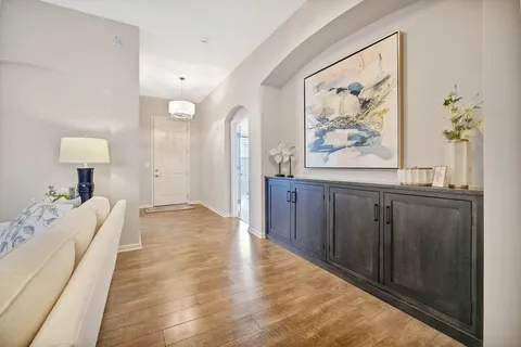 a spacious bedroom with a bed and a painting on the wall