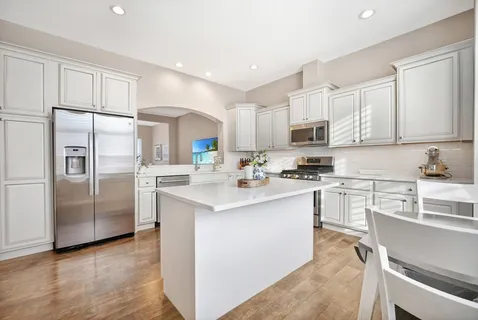 a kitchen with stainless steel appliances a refrigerator stove microwave and cabinets