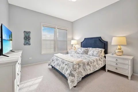 a bedroom with a bed and a desk