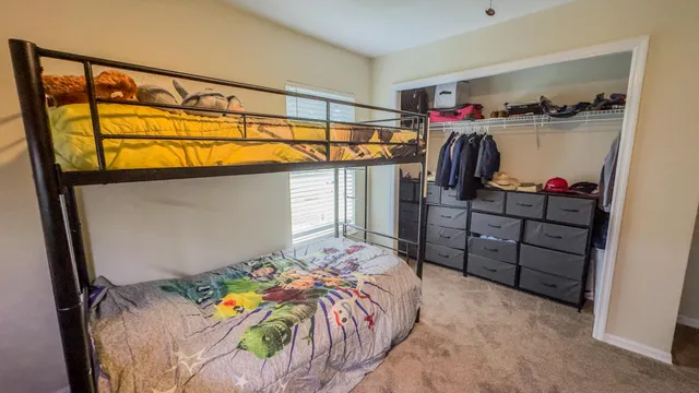a bedroom with a bed and a closet