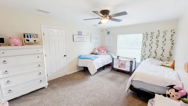 a bedroom with a bed and a dresser