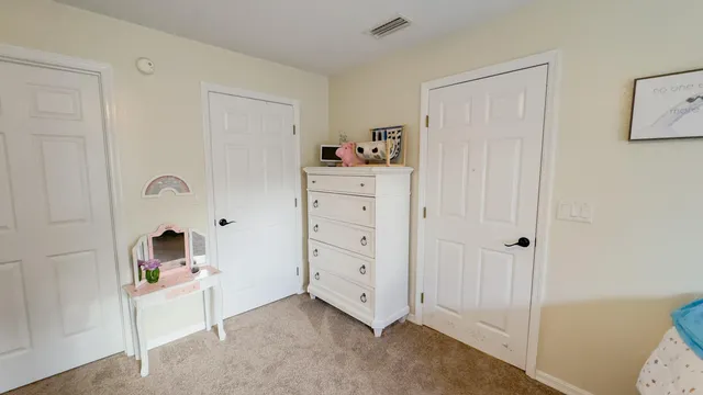 a room with a baby crib and a dresser