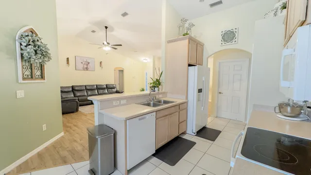 a spacious bathroom with a sink a mirror a bathtub and shower