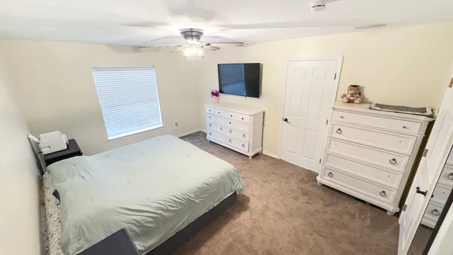 a bedroom with a bed and a dresser