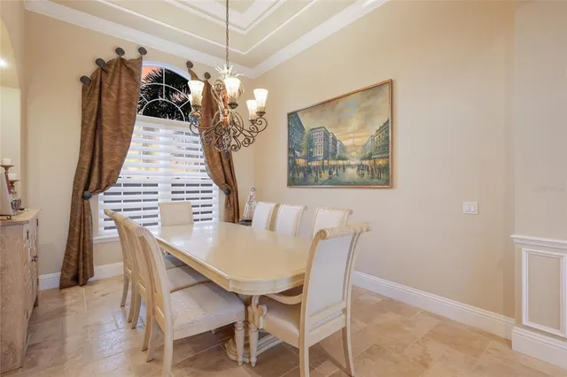 a living room with furniture a flat screen tv and a floor to ceiling window