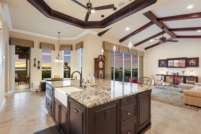 a bedroom with a large bed and a chandelier
