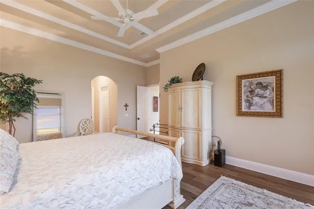 a living room with furniture a bookshelf and a large window