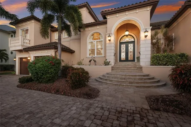a view of a house with a potted plants and a bench